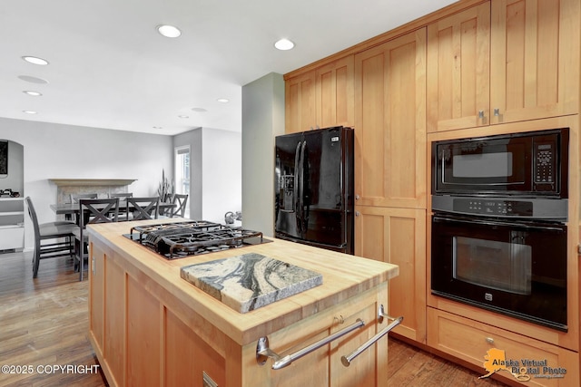 7521 Labrador Cir, Anchorage, AK 99502 - kitchen with black appliances, wooden counters, a kitchen island, light wood-type flooring, and recessed lighting