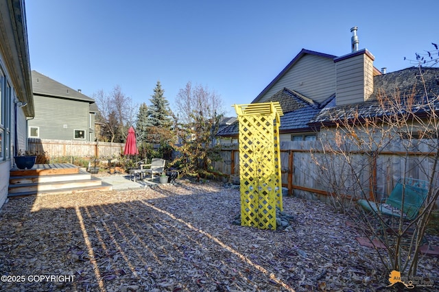 7521 Labrador Cir, Anchorage, AK 99502 - fenced backyard featuring a patio area