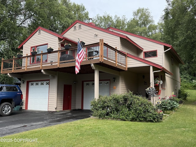 11741 Mary Ave, Anchorage, AK 99515 - view of front of property with an attached garage, a front lawn, a wooden deck, and asphalt driveway