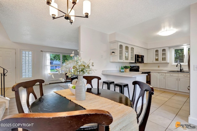 3116 Briarcliff Dr, Anchorage, AK 99508 - dining room featuring a chandelier, a textured ceiling, light tile patterned floors, and a baseboard radiator