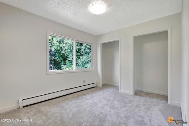 3116 Briarcliff Dr, Anchorage, AK 99508 - unfurnished bedroom featuring baseboard heating, a textured ceiling, and carpet flooring