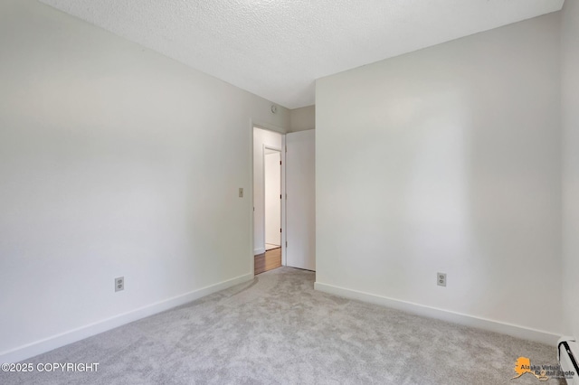 3116 Briarcliff Dr, Anchorage, AK 99508 - carpeted empty room with baseboard heating and a textured ceiling