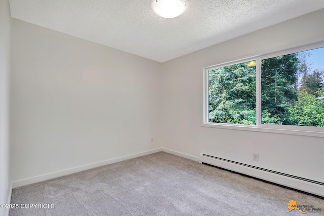 3116 Briarcliff Dr, Anchorage, AK 99508 - carpeted empty room with a baseboard radiator and a textured ceiling