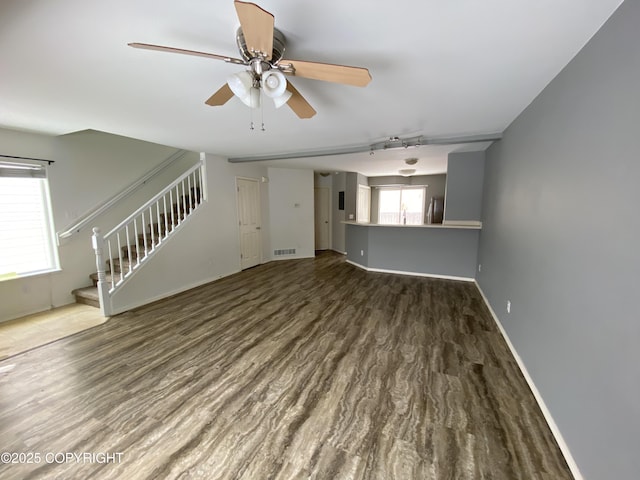 114 Rusty Allen Pl # 31, Anchorage, AK 99504 - unfurnished living room with stairway, a ceiling fan, wood finished floors, and track lighting