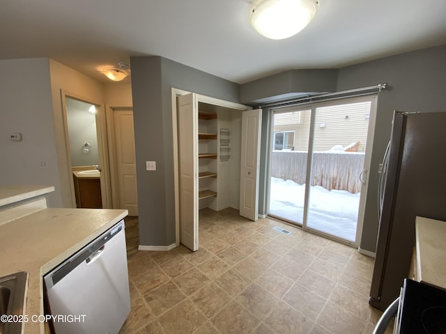 114 Rusty Allen Pl # 31, Anchorage, AK 99504 - kitchen featuring stainless steel dishwasher, light countertops, freestanding refrigerator, and range
