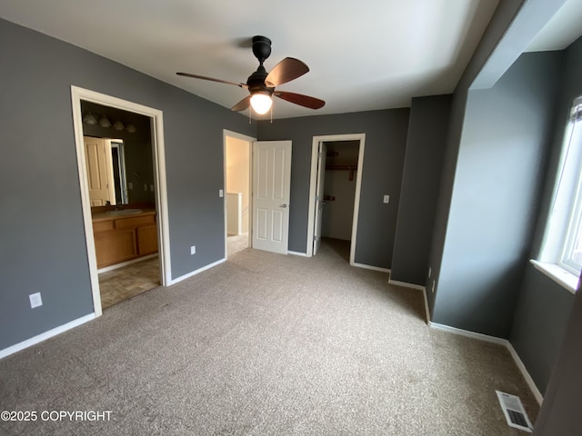 114 Rusty Allen Pl # 31, Anchorage, AK 99504 - unfurnished bedroom featuring carpet, ensuite bath, a walk in closet, and a ceiling fan