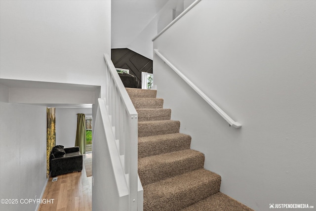 9755 Newhaven Loop, Anchorage, AK 99507 - stairs featuring healthy amount of natural light, wood finished floors, and vaulted ceiling