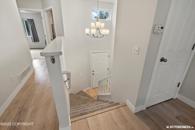 9755 Newhaven Loop, Anchorage, AK 99507 - staircase with wood finished floors and a chandelier