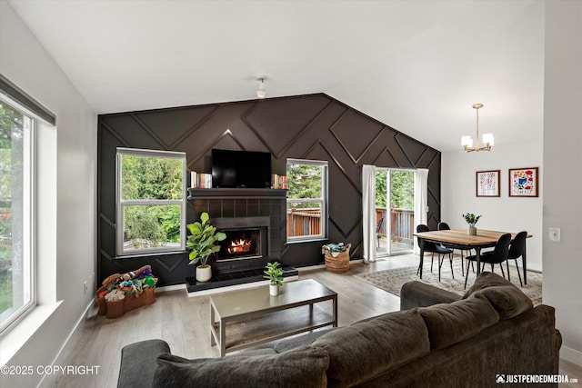 9755 Newhaven Loop, Anchorage, AK 99507 - living area featuring lofted ceiling, a chandelier, healthy amount of natural light, and wood finished floors