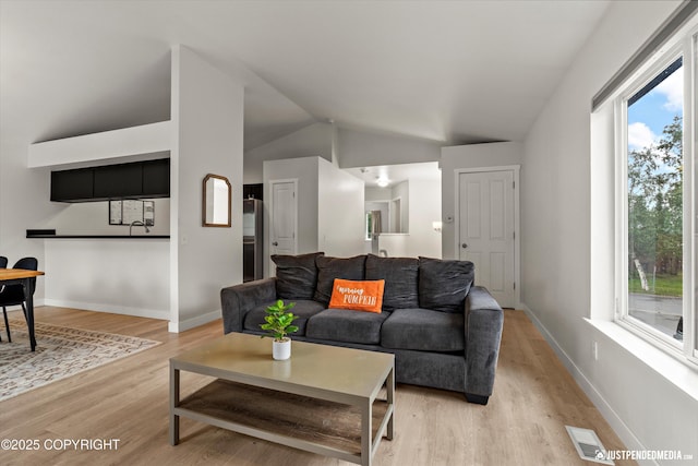 9755 Newhaven Loop, Anchorage, AK 99507 - living area with vaulted ceiling, light wood finished floors, and plenty of natural light