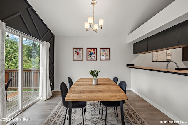 9755 Newhaven Loop, Anchorage, AK 99507 - dining area featuring a chandelier, vaulted ceiling, and wood finished floors