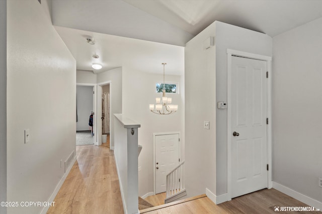 9755 Newhaven Loop, Anchorage, AK 99507 - hallway with light wood-type flooring and a chandelier