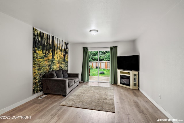 9755 Newhaven Loop, Anchorage, AK 99507 - unfurnished living room with wood finished floors and baseboards
