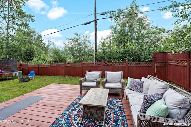 8410 E 20th Ave, Anchorage, AK 99504 - wooden terrace featuring a trampoline, an outdoor living space, and a fenced backyard