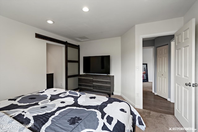8410 E 20th Ave, Anchorage, AK 99504 - bedroom featuring carpet flooring, recessed lighting, and a barn door