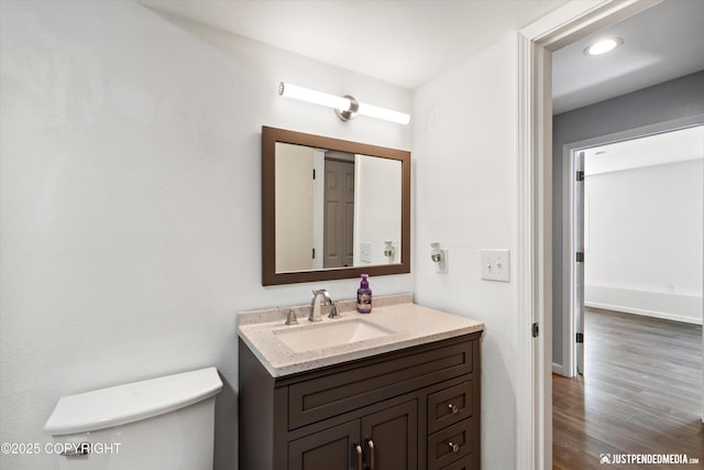 8410 E 20th Ave, Anchorage, AK 99504 - bathroom with vanity, wood finished floors, and recessed lighting