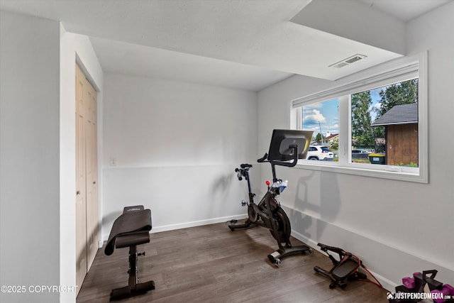 8410 E 20th Ave, Anchorage, AK 99504 - workout area featuring baseboards and wood finished floors