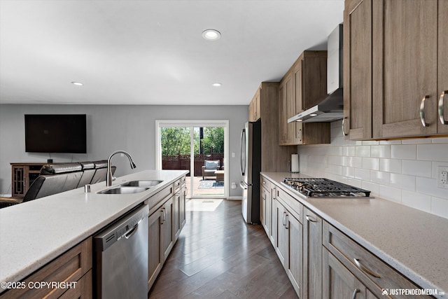 8410 E 20th Ave, Anchorage, AK 99504 - kitchen with appliances with stainless steel finishes, wall chimney range hood, dark wood-type flooring, tasteful backsplash, and recessed lighting