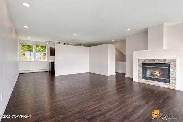 1414 W 7th Ave # 3, Anchorage, AK 99501 - unfurnished living room featuring dark wood-style flooring, a baseboard heating unit, a fireplace, and recessed lighting