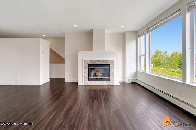 1414 W 7th Ave # 3, Anchorage, AK 99501 - unfurnished living room with a baseboard heating unit, dark wood-style floors, recessed lighting, and a fireplace