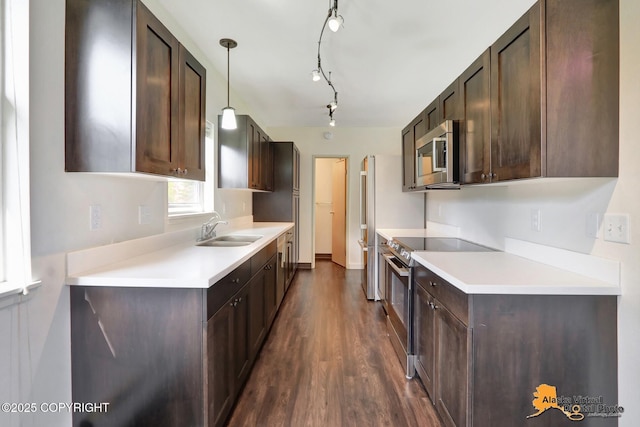 1414 W 7th Ave # 3, Anchorage, AK 99501 - kitchen featuring appliances with stainless steel finishes, dark brown cabinetry, dark wood-style flooring, light countertops, and decorative light fixtures