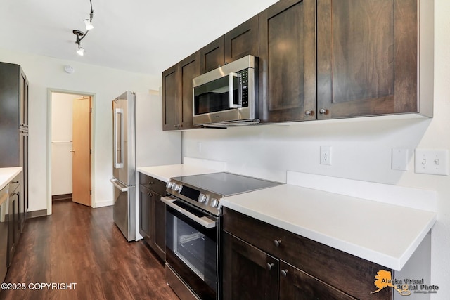 1414 W 7th Ave # 3, Anchorage, AK 99501 - kitchen featuring appliances with stainless steel finishes, dark brown cabinets, dark wood-type flooring, and light countertops