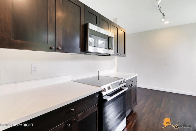 1414 W 7th Ave # 3, Anchorage, AK 99501 - kitchen featuring stainless steel microwave, electric stove, dark wood-type flooring, light countertops, and dark brown cabinets