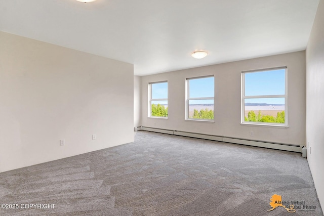 1414 W 7th Ave # 3, Anchorage, AK 99501 - spare room featuring a baseboard heating unit and carpet floors