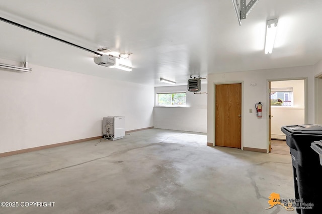 1414 W 7th Ave # 3, Anchorage, AK 99501 - garage with a garage door opener and baseboards