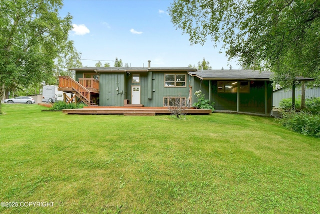 12145 Rainbow Ave, Anchorage, AK 99516 - rear view of property featuring a deck, a lawn, and board and batten siding