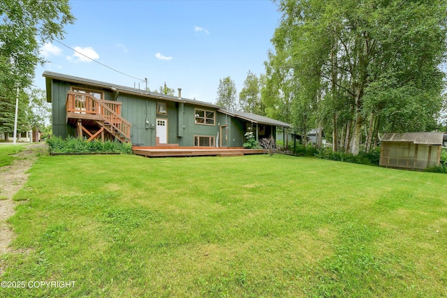 12145 Rainbow Ave, Anchorage, AK 99516 - back of house featuring a deck, a yard, a storage unit, and stairway