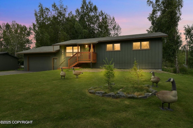 12145 Rainbow Ave, Anchorage, AK 99516 - ranch-style home featuring an attached garage, driveway, a yard, and board and batten siding