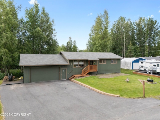12145 Rainbow Ave, Anchorage, AK 99516 - ranch-style house featuring an attached garage, asphalt driveway, and a front yard