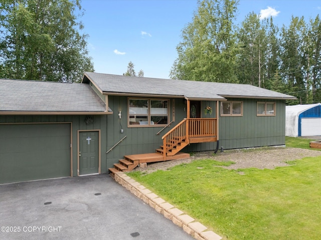 12145 Rainbow Ave, Anchorage, AK 99516 - view of front facade with a front yard, a garage, asphalt driveway, and a shingled roof