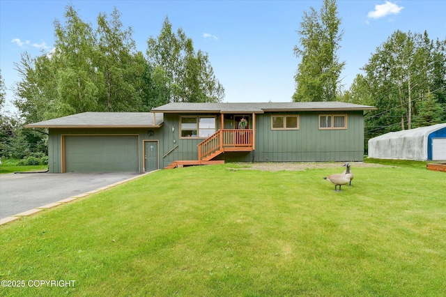 12145 Rainbow Ave, Anchorage, AK 99516 - view of front of home with driveway, an attached garage, and a front lawn