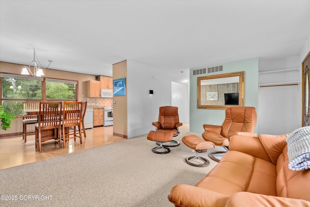12145 Rainbow Ave, Anchorage, AK 99516 - living area featuring a chandelier and light colored carpet