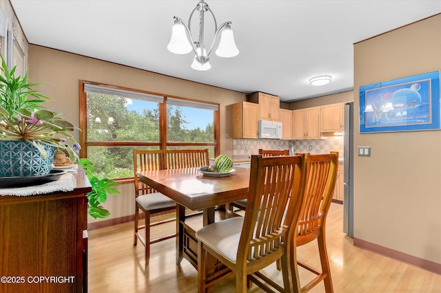 12145 Rainbow Ave, Anchorage, AK 99516 - dining space featuring a chandelier and light wood-style flooring