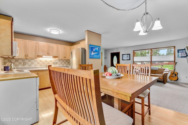 12145 Rainbow Ave, Anchorage, AK 99516 - dining area with a chandelier and light wood-type flooring