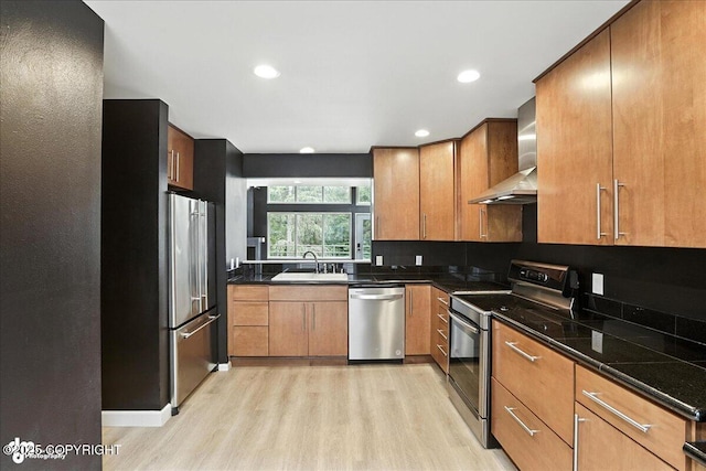 2433 La Honda Dr, Anchorage, AK 99517 - kitchen with stainless steel appliances, wall chimney range hood, light wood-type flooring, brown cabinetry, and recessed lighting