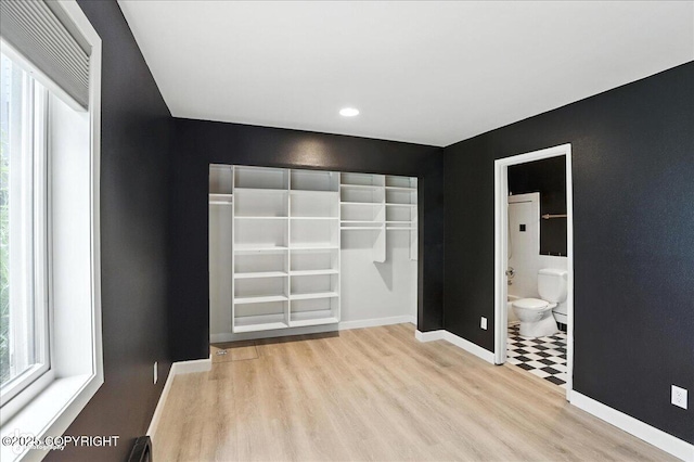 2433 La Honda Dr, Anchorage, AK 99517 - unfurnished bedroom with wood finished floors, recessed lighting, and ensuite bath