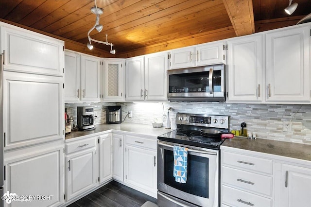 4733 Becharof St, Anchorage, AK 99507 - kitchen featuring appliances with stainless steel finishes, a wooden ceiling with exposed beams, white cabinetry, tasteful backsplash, and track lighting