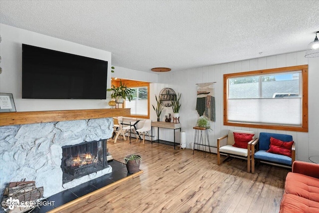 4733 Becharof St, Anchorage, AK 99507 - living room featuring a textured ceiling, wood finished floors, and a fireplace
