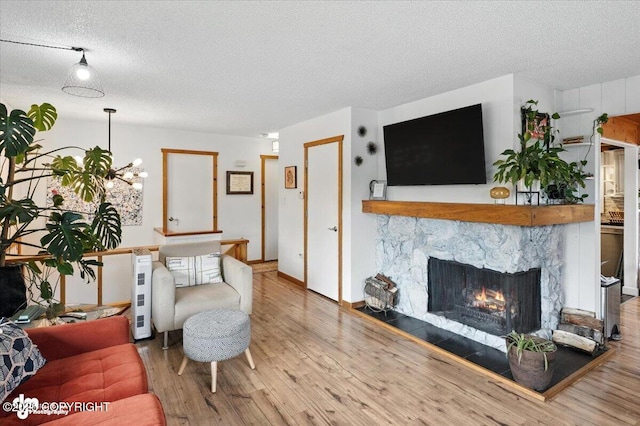 4733 Becharof St, Anchorage, AK 99507 - living room with wood finished floors, a textured ceiling, and a fireplace