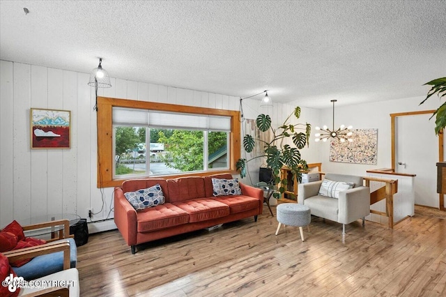 4733 Becharof St, Anchorage, AK 99507 - living area featuring a baseboard heating unit, wood-type flooring, a chandelier, a textured ceiling, and wooden walls