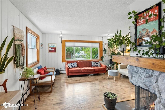 4733 Becharof St, Anchorage, AK 99507 - living area featuring hardwood / wood-style flooring, a textured ceiling, wooden walls, and a baseboard heating unit