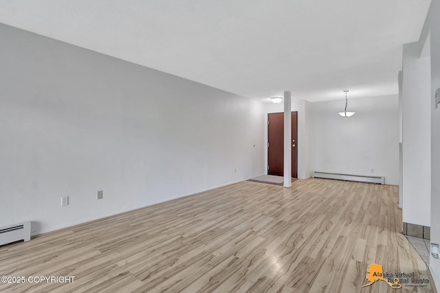 4650 Reka Dr # F6, Anchorage, AK 99508 - spare room featuring a baseboard radiator and light wood-type flooring