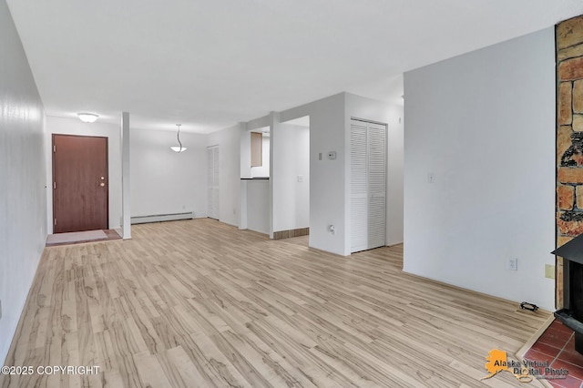 4650 Reka Dr # F6, Anchorage, AK 99508 - unfurnished living room with a baseboard heating unit and light wood-style flooring