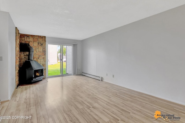 4650 Reka Dr # F6, Anchorage, AK 99508 - unfurnished living room featuring a baseboard heating unit, wood finished floors, and a wood stove