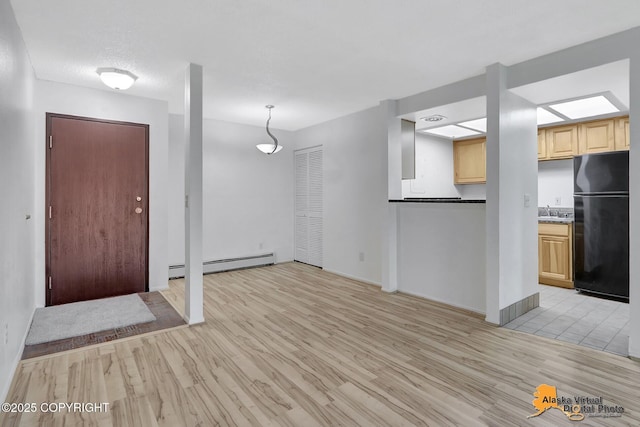 4650 Reka Dr # F6, Anchorage, AK 99508 - foyer entrance featuring baseboard heating and light wood-type flooring
