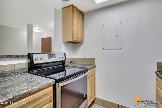 4650 Reka Dr # F6, Anchorage, AK 99508 - kitchen with electric range, electric panel, light brown cabinetry, light tile patterned floors, and dark countertops
